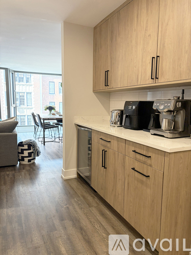 A kitchen with wooden cabinets and a white countertop.