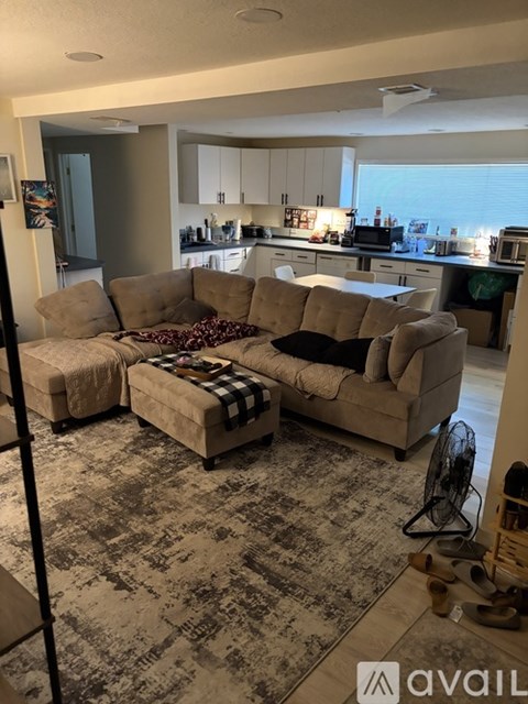 A living room with a couch and a rug.