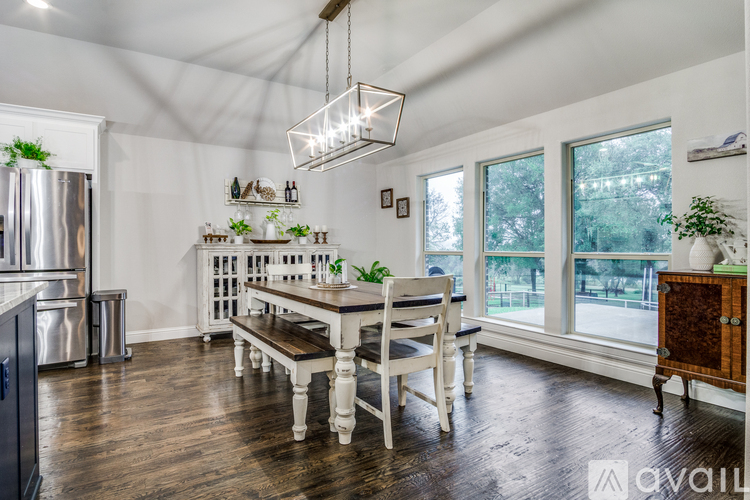 A dining room with a wooden table and chairs.