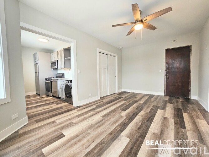 A room with a wood floor and a ceiling fan.