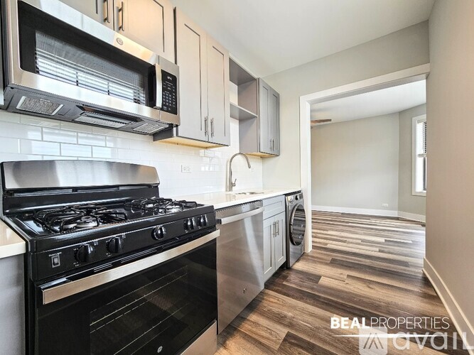 A modern kitchen with a black stove top oven and microwave above it.
