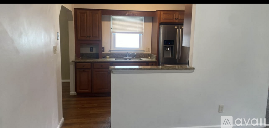 A kitchen with wooden cabinets and a white countertop.