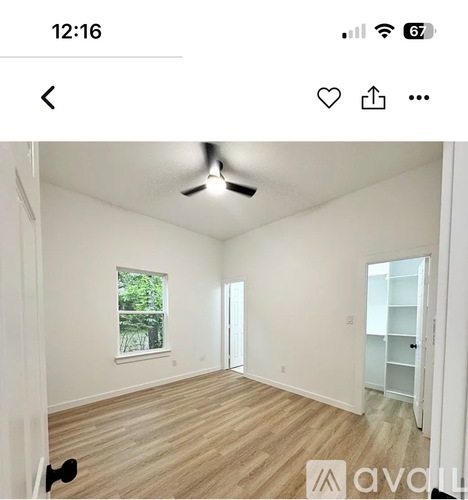 A room with a ceiling fan and a window.