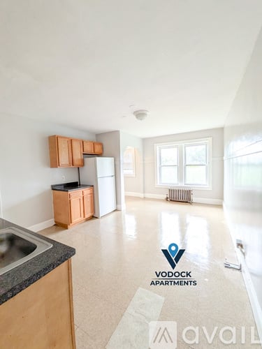 A spacious apartment with a kitchen area and a living room.