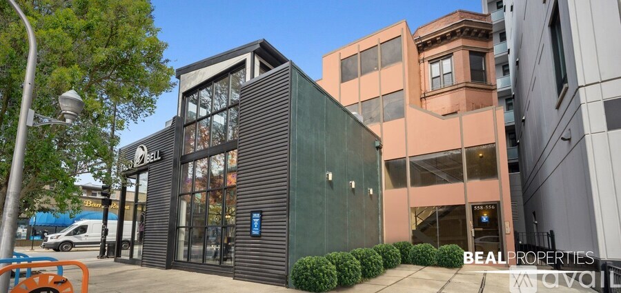 A modern building with a glass facade is labeled as "BEALPROPERTIES AVAIL".