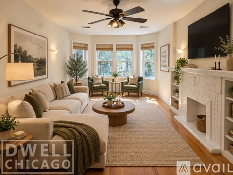 A living room with a fireplace and a television on the wall.