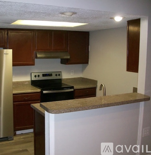 A kitchen with a stove and oven built into the counter.