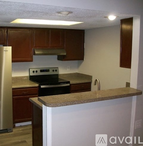 A kitchen with a stove and oven built into the counter.
