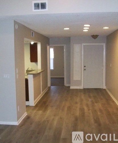 A room with wooden floors and white walls.