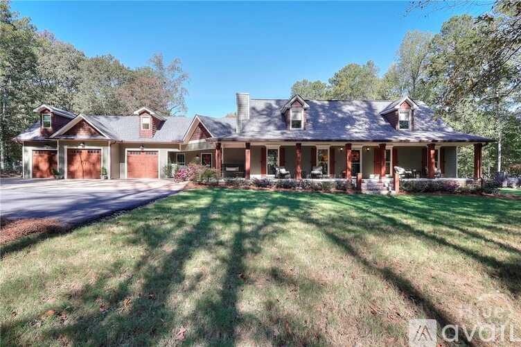 A large house with a porch and a covered driveway.
