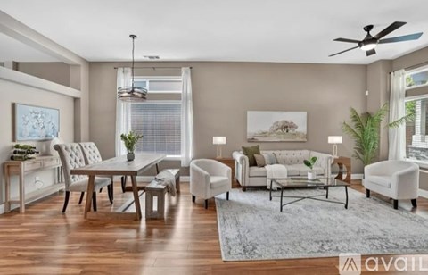 A living room with a dining table and chairs.
