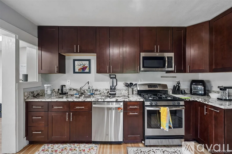 A kitchen with brown cabinets and a white counter top.