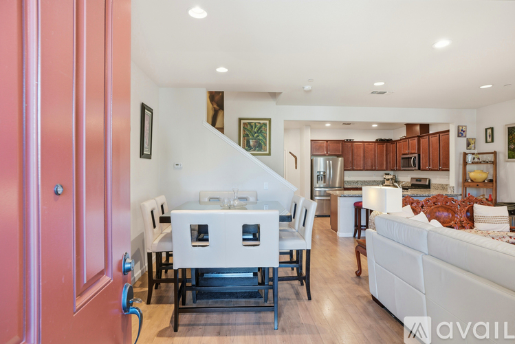 A modern kitchen with a dining table and chairs.