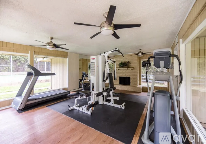 A home gym with a treadmill, elliptical trainer, and a weight machine.