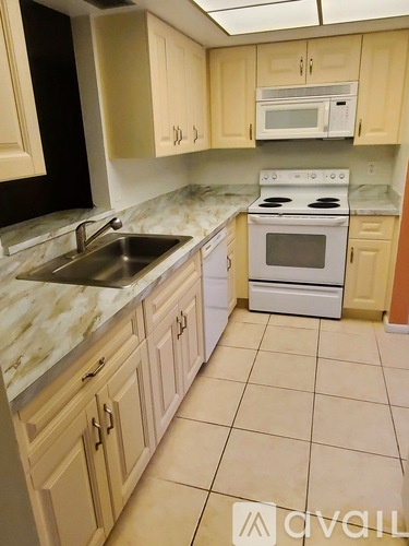 A kitchen with a white oven and sink.