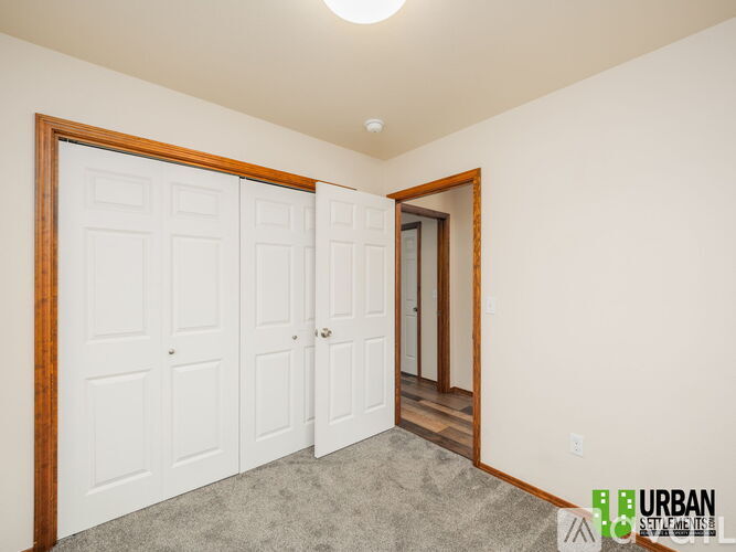A room with a white door and a brown frame.