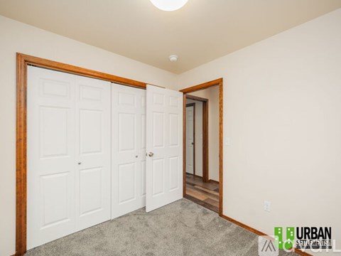 A room with a white door and a brown frame.