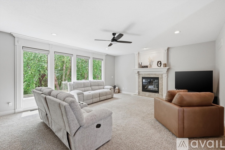 A living room with a grey sofa, a fireplace, and a television.