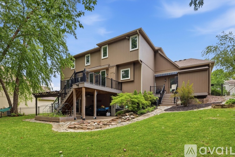 A house with a brown exterior and a deck with a railing.