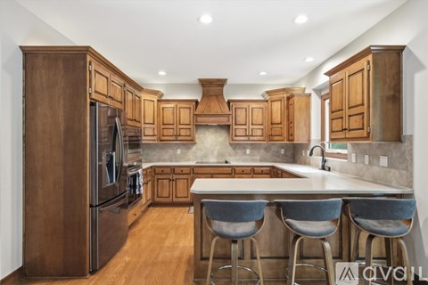 A kitchen with wooden cabinets and a white countertop.