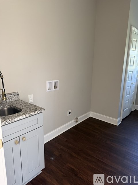 A kitchen with a sink and a cabinet.