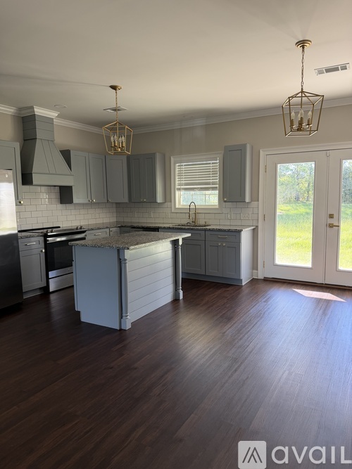 A kitchen with dark wood floors and a white countertop.