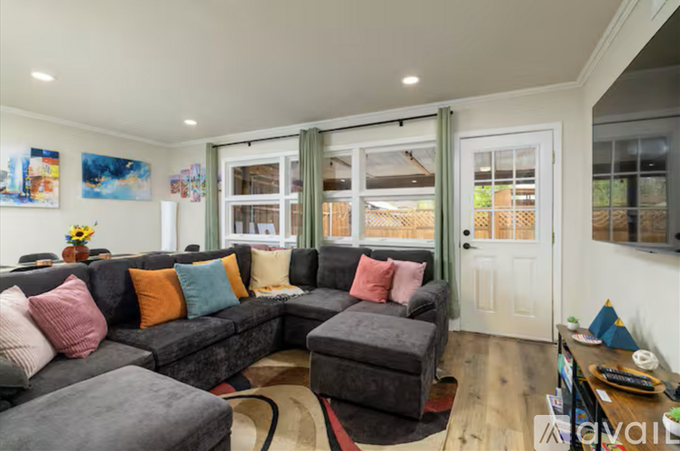 A living room with a grey couch and a coffee table.