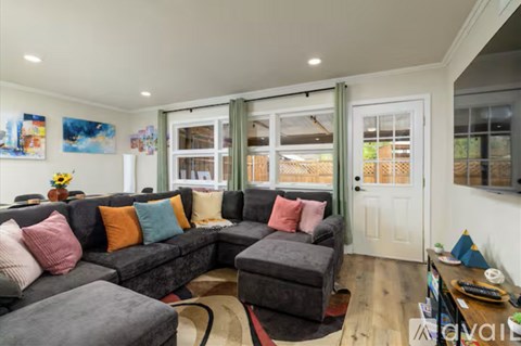 A living room with a grey couch and a coffee table.