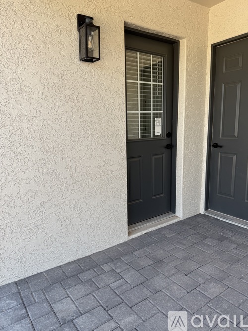 A black door with a window above it.