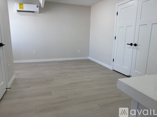 A room with a white door and a white table.