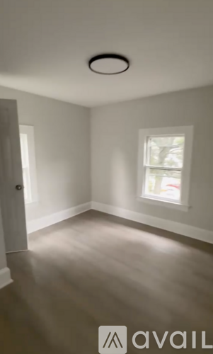 A room with a window and a door.