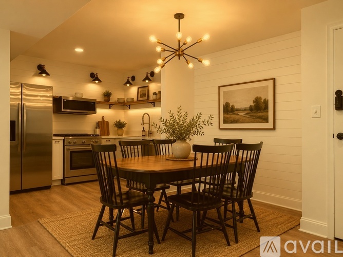 A dining room with a wooden table and chairs.