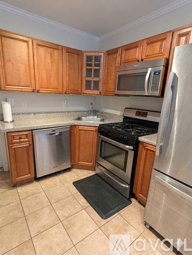 A kitchen with wooden cabinets and stainless steel appliances.