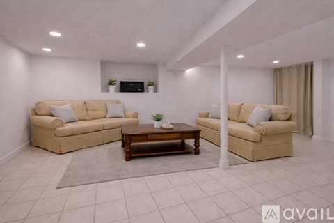 A living room with two beige sofas and a coffee table.