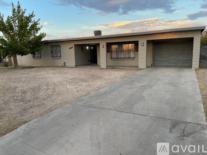 A two-story house with a garage and a driveway.