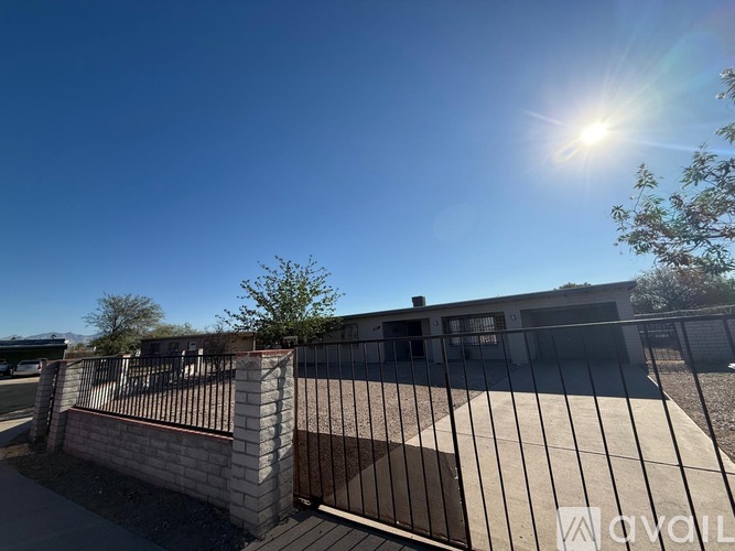 A sunny day at a gated community entrance with a clear blue sky.