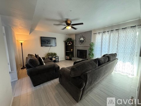 A living room with a grey sofa and a black floor lamp.