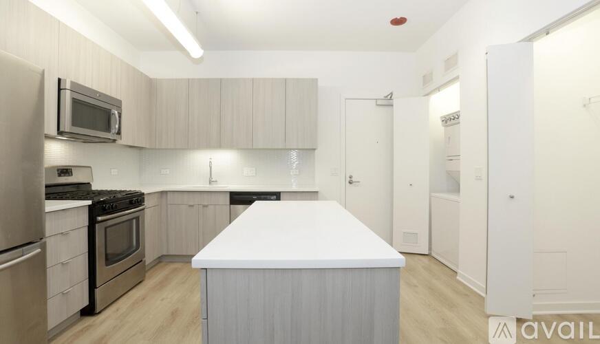 A kitchen with a white island in the middle.