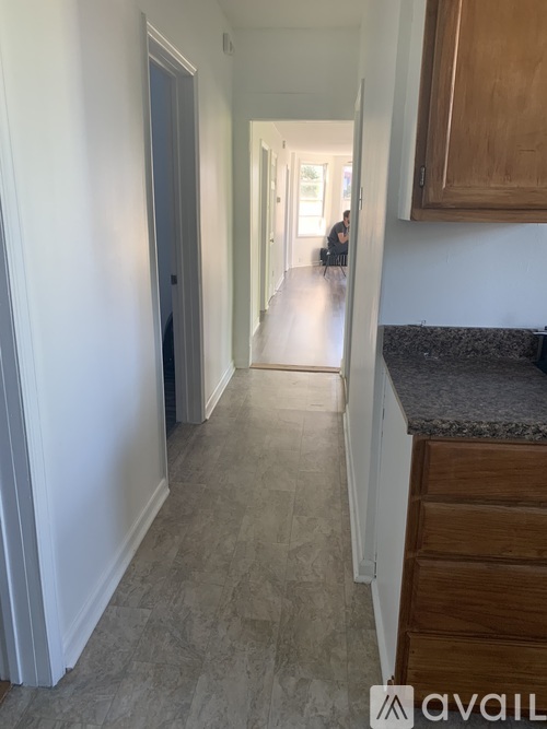 A hallway with a person walking in the distance.
