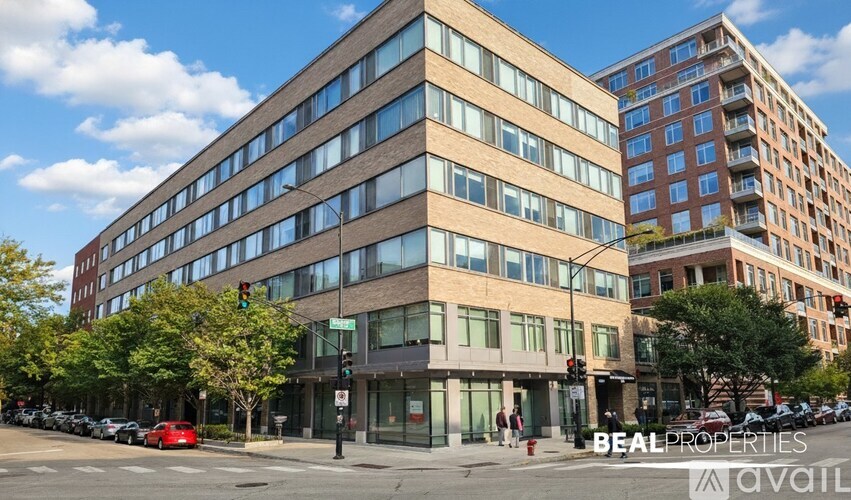 A street view of a multi-story building with the sign "BEALPROPERTIES" on the front.