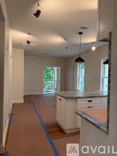 A kitchen under renovation with white cabinets and a countertop.