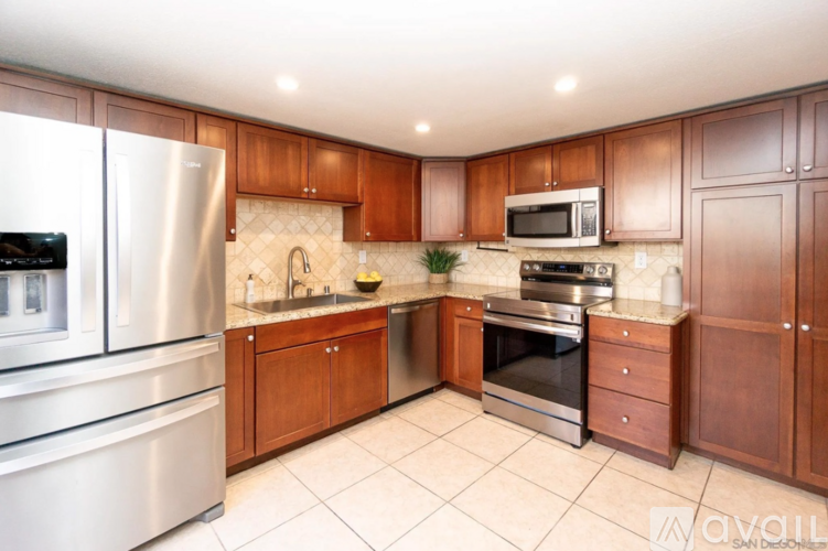 A kitchen with wooden cabinets and stainless steel appliances.