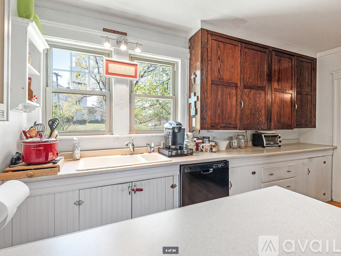 A kitchen with wooden cabinets and a window.