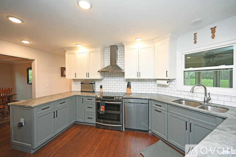 A kitchen with a stove top oven and a range hood.