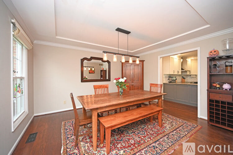 A dining room with a wooden table and chairs.