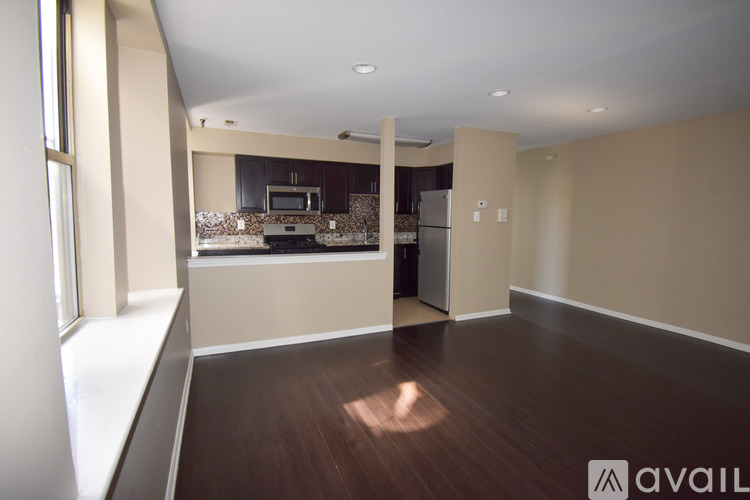 A spacious kitchen with a dining area in the background.