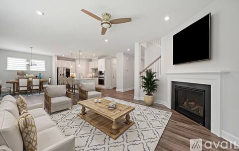 A living room with a fireplace and a television mounted on the wall.