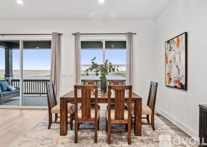 A dining room with a table set for four.