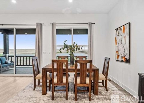 A dining room with a table set for four.