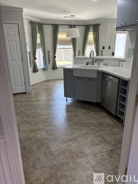 A kitchen with a sink and a dishwasher.
